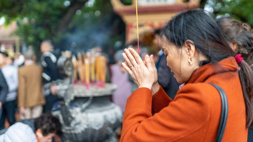 Woman Praying During Tet In Hanoi